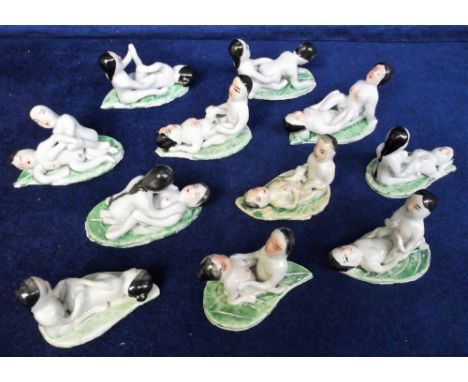 Collectables erotica, 11 glazed ceramic Japanese figures showing positions of the Kamasutra, each couple mounted on a green l