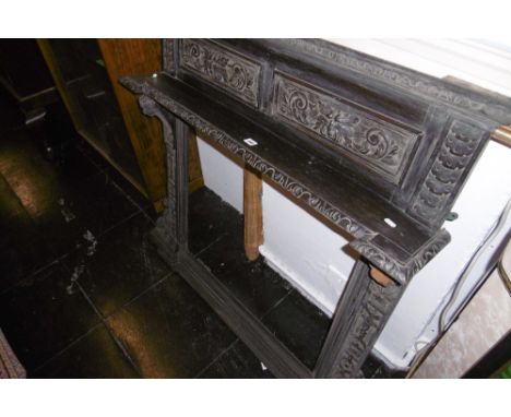 A CARVED OVERMANTLE SURROUND