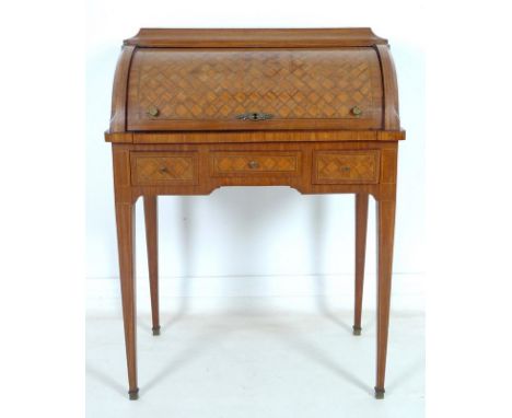 A French early 20th century roll top writing bureau, the body inlaid overall with geometric parquetry, caddy top over the bar