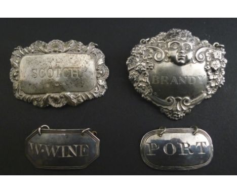 A collection of George III and later silver decanter labels, comprising 'W. Wine', of plain canted rectangle form, with line 