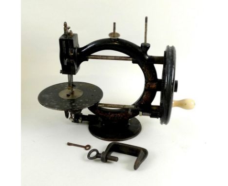 A Wanzer manual sewing machine, circa 1880, decorated with black lacquer and gilt, Time Utilizer Trade Mark, No 133552, 32 by