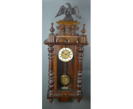 A Victorian Vienna wall clock, the cream enamel and gilt brass dial with Roman numerals, conforming pendulum, eagle finial, w
