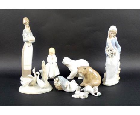 A group of five Lladro figurines, comprising a girl holding a lamp, a seated girl with Arum lilies, a Polar bear, a Brown bea