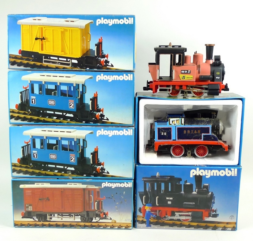 A group of vintage Playmobil model railway, comprising three locos, two passenger coaches, and tw