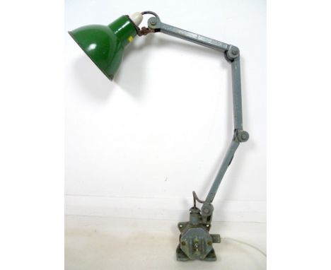A machinist-engineer's adjustable work-lamp, circa 1930's, articulated cantilever structure, cast iron base with toggle switc