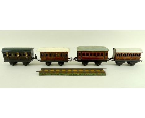 A group of O gauge tinplate coaches, early 20th century, comprising two Marklin passenger coaches, with working doors, 'Midla