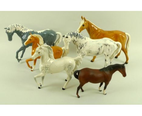 A group of five Royal Doulton figurines, each modelled as a horse, comprising two unglazed and partially painted, a dapple gr