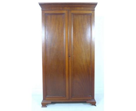 A mid 20th century small mahogany and oak two door wardrobe, dentil moulded cornice, ogee bracket feet, 93 by 34.5 by 167.5cm