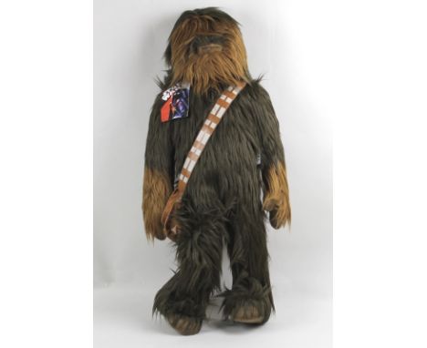 A Star Wars soft toy figure of a Wookie, possibly Chewbacca, complete with sash and original label, 70cm long.