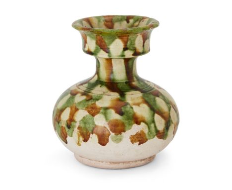 A Chinese sancai-glazed spittoon, zhadou, Tang dynasty, of compressed globular form standing on a short foot rising to a narr