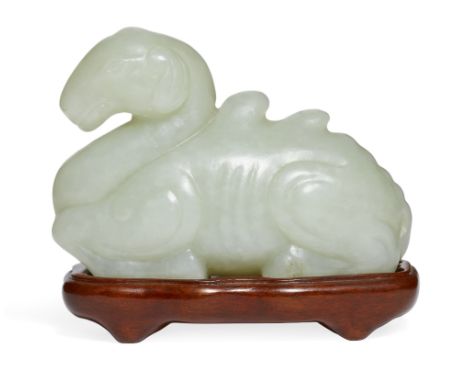 A Chinese Song-style celadon jade carving of a recumbent camel, 19th century, naturalistically carved as a recumbent camel wi