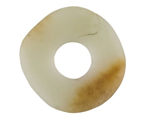 A Chinese pale green jade bi, 18th/19th century, with russet inclusion to one side, 3.5cm diameter十八/十九世紀 玉璧Please refer to d