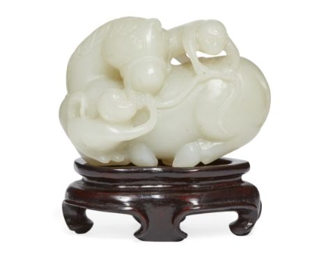 A Chinese pale celadon jade 'ma shang feng hou' carving, late 19th century, carved with two monkeys clambering atop of and pl