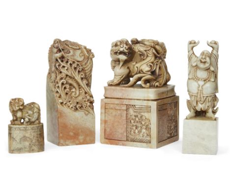 A group of four large Chinese soapstone seals, 19th/20th century, the first with horned mythical beats and cubs finial, the b