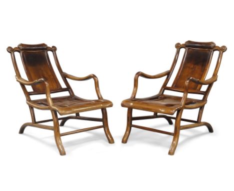 A pair of Chinese hongmu reclining 'moongazing' chairs, late Qing dynasty, the shaped scroll-cared top rail above solid back 