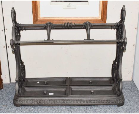 A reproduction patinated cast iron stick stand decorated with scroll work, 88cm by 40cm by 82cm