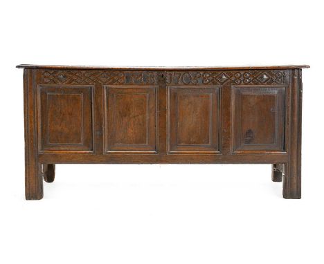 An Early 18th Century Joined Oak Chest, initialled MB and dated 1705, the hinged lid enclosing a vacant interior above a stra
