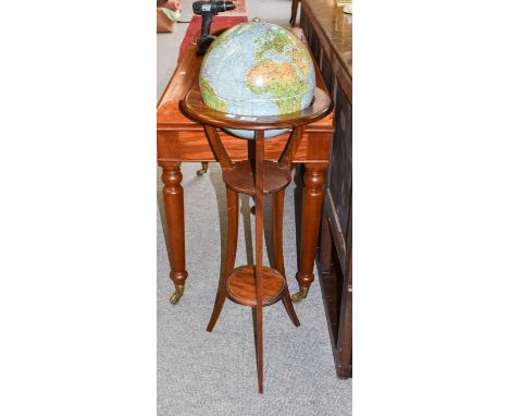 A 20th century revolving globe on mahogany stand