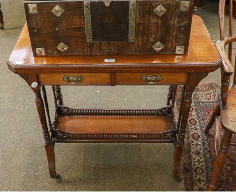 An Aesthetic period mahogany foldover card table fitted with two drawers, the turned supports joined by a gallery shelf stret