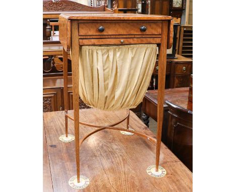 An early 19th century satinwood work tableCondition report: The top is very slightly warped and with some veneer cracks. Poli