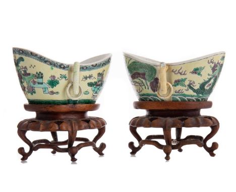 NEAR PAIR OF CHINESE FAMILLE VERTE SHAPED BOWLS LIKELY QING DYNASTY decorated in enamels on pale yellow ground, the first fea
