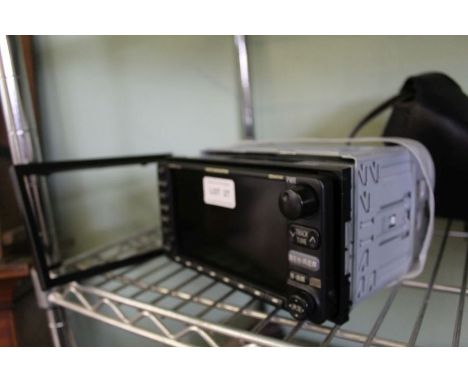 A cased Cannon Eos 650 camera together with a Toyota 16020 in car entertainment controller