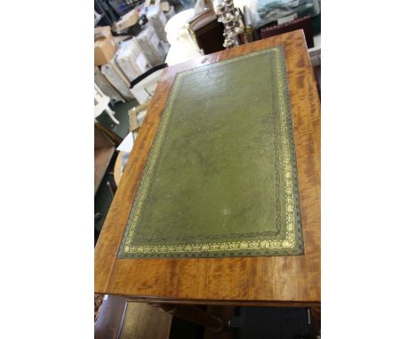 A satinwood writing table, scriver insert top over two inline drawers on four turned legs with white ceramic casters