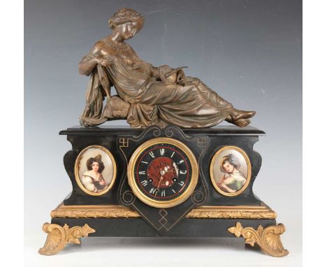 A late 19th century French slate and spelter mantel clock with eight day movement striking on a bell, the circular dial with 
