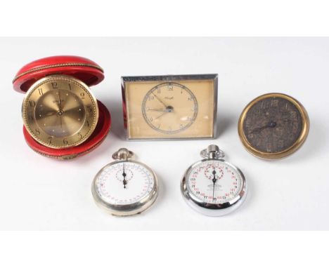 A Swiza gilt metal circular cased travelling alarm clock with eight day movement and red leather covered folding case, diamet