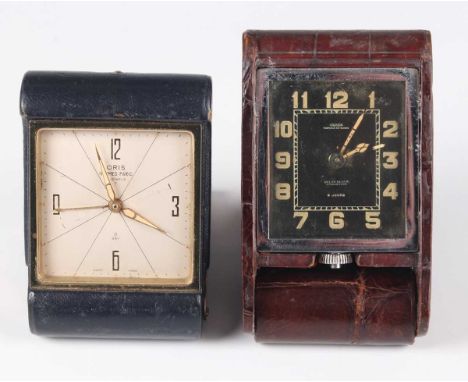 A Jaeger leather mounted travelling timepiece with eight day movement, the signed black dial with luminous Arabic hour numera
