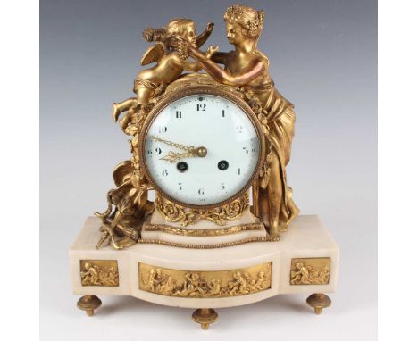 A late 19th century French ormolu and white marble mantel clock with eight day movement striking on a bell, the circular enam