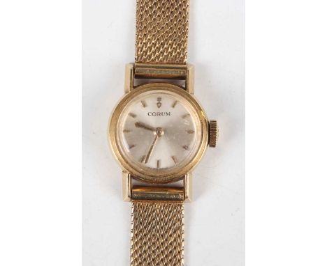 A Corum 18ct gold circular cased lady’s wristwatch, the signed silvered dial with gilt baton hour markers and gilt hands, cas
