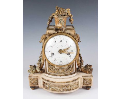 A late 18th century French ormolu and white marble mantel clock, the eight day movement with silk suspension striking on a be