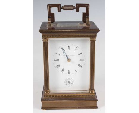 A modern brass cased carriage alarm clock with eight day movement striking hours and alarm on a gong, the backplate detailed 