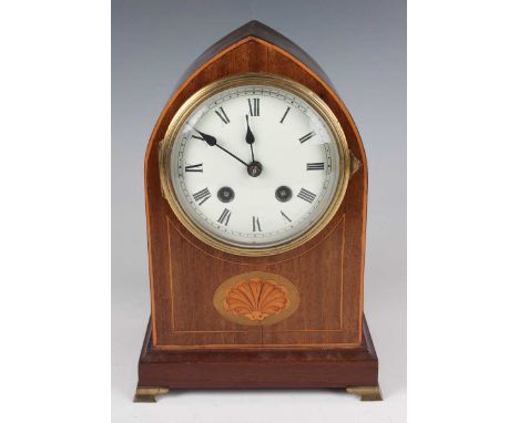 An Edwardian mahogany lancet arched mantel clock with eight day movement striking on a gong, the white enamelled circular dia