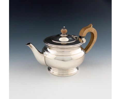 A modern silver tea pot, by The Cooper Brothers, Sheffield 1979, circular bellied form, scroll handle, domed hinged cover wit