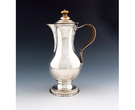 λ A George III old Sheffield plated hot water jug, by Henry Tudor and Co, circa 1765, baluster form, scroll handle with trace