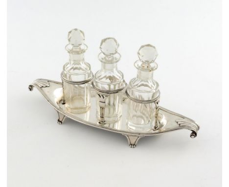 A George III silver three bottle sauce bottle frame, by Richard Cooke, London 1800, wire-work frame, fluted columns, on an ov