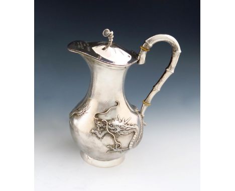 λ A Chinese silver ewer, by Yokshang, also marked with Chinese characters, baluster form, embossed with a dragon on a matted 