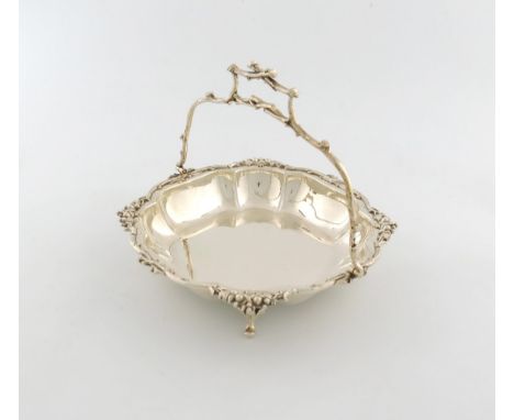A silver swing-handled basket, by Jenkins and Timm, Sheffield 1914, shaped square form, branch and berry border, simulated br