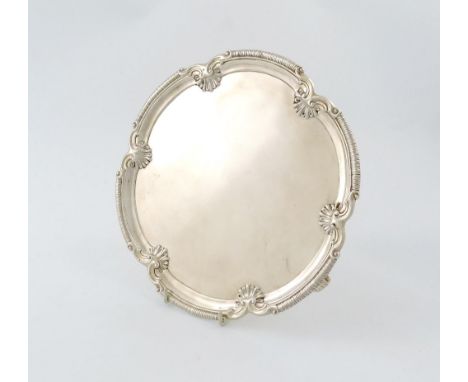 A George II silver salver, by David Bell, London 1759, shaped circular form, gadroon, scroll and shell border, on three scrol