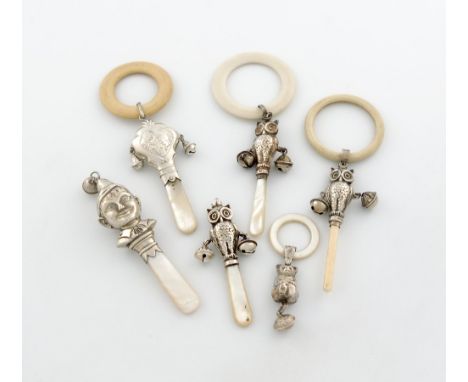 λ A small collection of six silver rattles, various dates and makers, comprising: one modelled as a pixie's head, Birmingham 