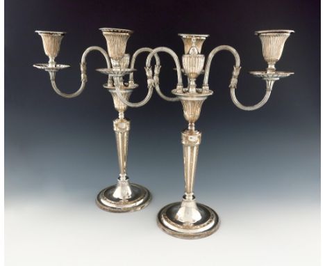 A pair of George III old Sheffield plated two-light candelabra, probably by Winter and Co, circa 1780, tapering circular form