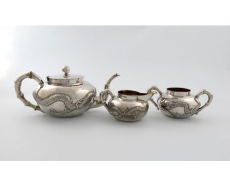 A three-piece Chinese silver tea set, by Lainchang, also marked with Chinese characters, circular bellied form, embossed with