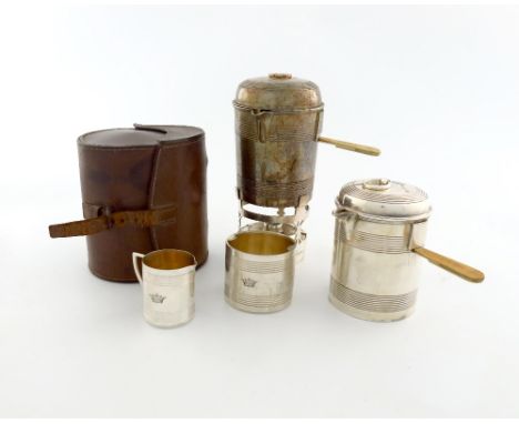 λ A Victorian electroplated travelling picnic tea set, by R. Hodd and Sons, comprising: a hot water pot on a burner, tapering