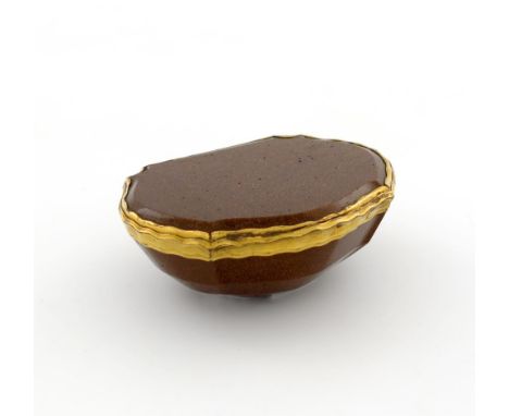 An 18th century gilt-metal mounted gold-stone snuff box, unmarked, cartouche form, wavy-edge mounts, length 7.8cm