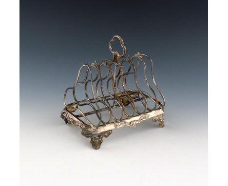 A Victorian silver seven-bar toast rack, by J. Edwards, London 1845, shaped bars, central carrying handle, on a shaped rectan