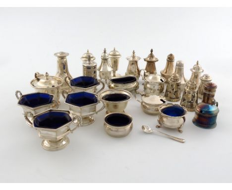 A large collection of assorted silver condiments, various makers and dates, comprising: a set of four salt cellars, by Hawksw