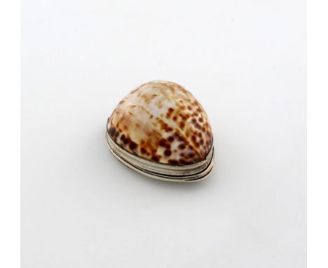 A late 18th / early 19th century silver-mounted cowrie shell snuff box, maker's mark only, PP, oval form, the hinged cover wi