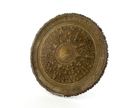 An Indian silver presentation salver, circular form, decorated with village scenes and foliate scroll decoration, on a matted